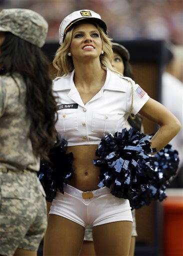 In this Nov. 17, 2013, file photo, Houston Texans cheerleader Caitlyn watches from the sideline during the second half of an NFL football game against the Oakland Raiders in Houston. Mike Ramirez is a Texas high school football player who spent most of his time on the bench last season and works part-time at a local McDonalds. Caitlyn is a Texans cheerleader whose life is devoted to intense workouts, coaching tumbling classes and studying communications at the University of Houston. Yet 10,000 retweets later, the two are headed to the prom this Saturday on a blind date resulting from social media. (AP Photo/Patric Schneider, File)