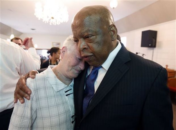 Rita Schwerner-Bender, widow of Michael Schwerner, one of three civil rights workers murdered in Neshoba County for their work in trying to register blacks to vote in then segregationist Mississippi, hugs U.S. Rep. John Lewis, D-Ga., a one-time Freedom Rider, during a commemorative service at Mt. Zion United Methodist Church in Philadelphia, Miss., Sunday, June 15, 2014. (AP Photo/Rogelio V. Solis)