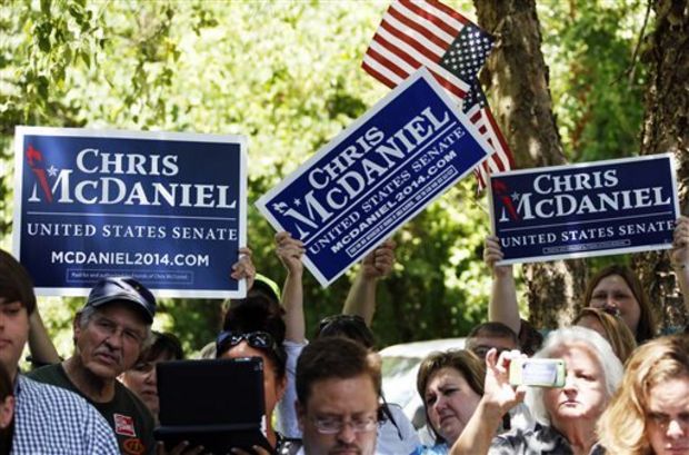 Supporters of state Sen. Chris McDaniel of Ellisville, Miss., who sought to unseat the incumbent U.S. Sen. Thad Cochran in the Republican primary, wave their signs and flags during a news conference by his attorneys and advisers in Jackson, Miss., Wednesday, July 16, 2014. Lawyers for tea party candidate McDaniel said that they intend, in the next 10 days, to file a challenge of McDaniel's loss to six-term Sen. Thad Cochran in the Mississippi Republican primary. Certified results of the June 24 runoff show Cochran won by 7,667 votes. (AP Photo/Rogelio V. Solis)