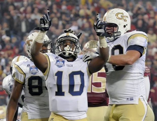 Georgia Tech running back Synjyn Days (10) celebrates his touchdown run against Florida State with offensive lineman Shaquille Mason, right, during the first half of the Atlantic Coast Conference championship NCAA college football game in Charlotte, N.C., Saturday, Dec. 6, 2014. (AP Photo/Mike McCarn)
