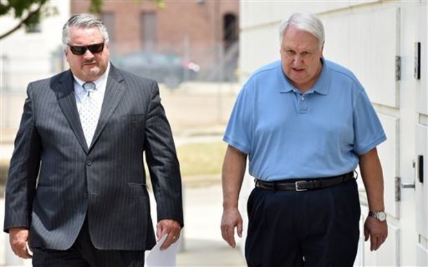 Former state Sen. Irb Benjamin, 68, of Madison, right, walks to the federal courthouse in downtown Jackson, Miss., Friday, Aug. 21, 2015 with attorney Joe Hollomon for a hearing on federal charges that he paid bribes and kickbacks to a former Mississippi corrections commissioner in exchange for contracts. Benjamin pleaded not guilty to three counts of conspiracy and bribery. He was released on $10,000 bond. (Rick Guy/The Clarion-Ledger, via AP)