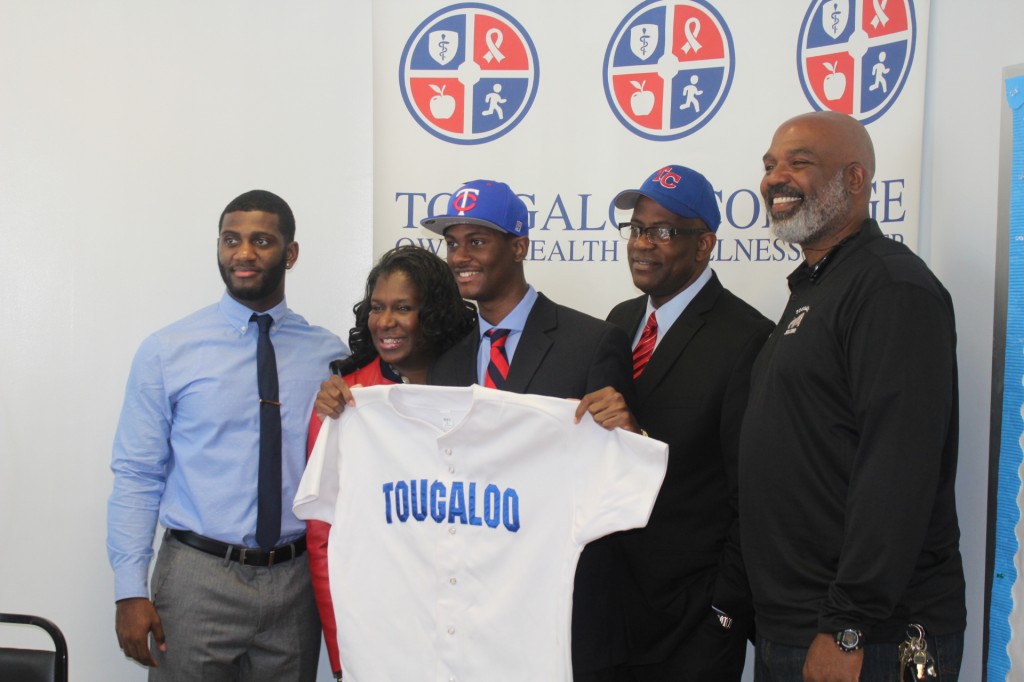 Jim Hill’s Isaiah Rush holds up his first Tougaloo College baseball jersey. He is standing with his brother Timothy Rush (from left), mother Linda Rush, father Timothy Rush Sr., and Earl Sanders, head baseball coach. 