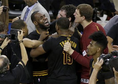 Cleveland Cavaliers forward LeBron James, top left, celebrates with teammates after Game 7 of basketball's NBA Finals against the Golden State Warriors in Oakland, Calif., Sunday, June 19, 2016. The Cavaliers won 93-89. (AP Photo/Eric Risberg)