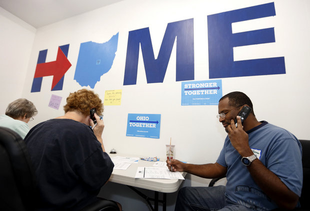 Phone volunteers Dy' Sheam West, right, of Jacksontown, Ohio, Terry Flash, center, of Buckeye Lake, Ohio, and Charlyn Rusk of Johnstown, Ohio, make calls seeking support for Hillary Clinton at the Ohio Together Hillary Clinton campaign office in Newark, Ohio, Thursday, Sept. 1, 2016. (AP Photo/Paul Vernon)