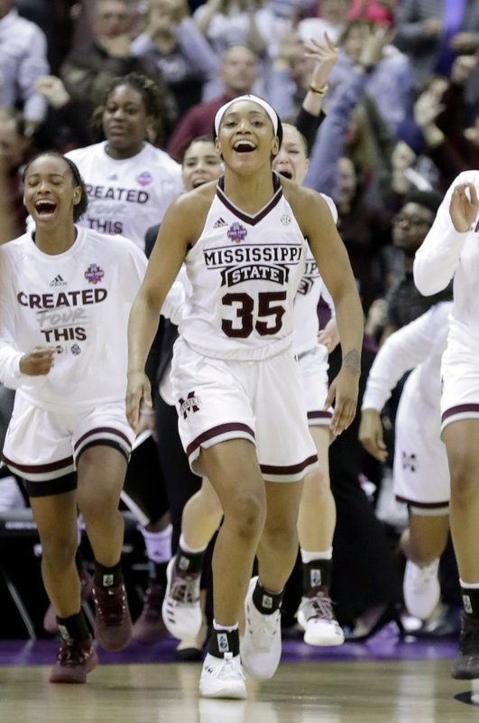 Mississippi State’s Victoria Vivians celebrates with her teammates after defeating Louisville in the semifinals of the women’s NCAA Final Four college basketball tournament, Friday, March 30, 2018, in Columbus, Ohio. Mississippi State won 73-63 in overtime. (AP Photo/Ron Schwane)