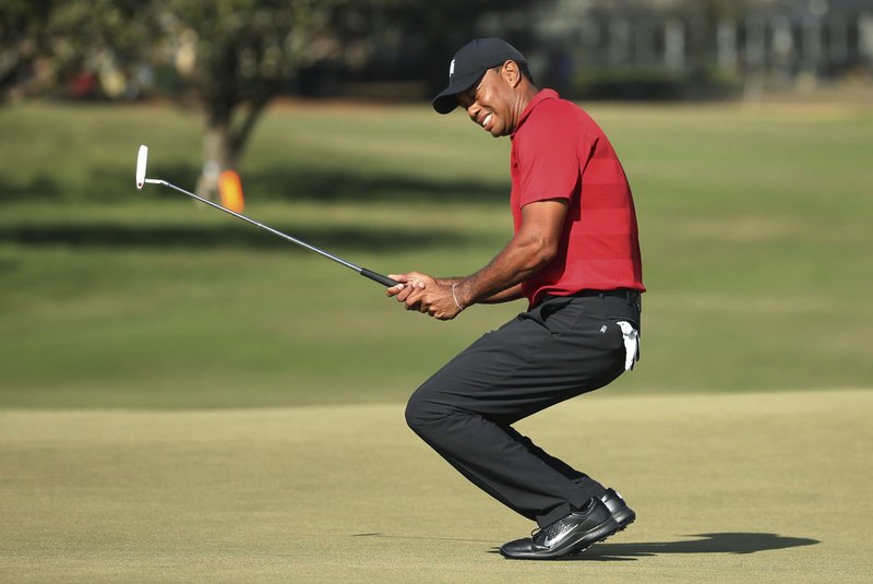 Tiger Woods grimaces after missing a putt on the 15th green during the final round of the Arnold Palmer Invitational golf tournament Sunday, March 18, 2018, in Orlando, Fla. (Stephen M. Dowell/Orlando Sentinel via AP) 