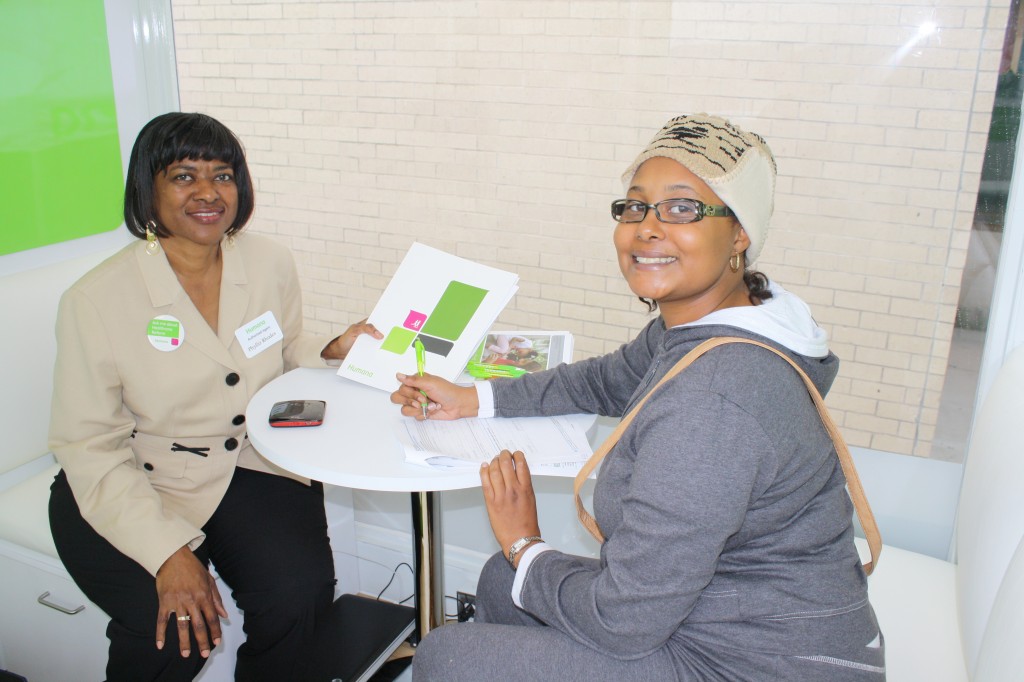 Authorized Humana insurance agent Phyllis Rhodes (left) answers questions and starts the enrollment process for Vieanna Nichols (right).