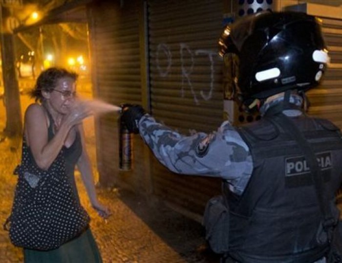 A military police peper sprays a protester during a demonstration in Rio de Janeiro, Brazil, Monday, June 17, 2013. Protesters massed in at least seven Brazilian cities for another round of demonstrations voicing disgruntlement about life in the country, raising questions about security during big events like the current Confederations Cup and the following month’s Papal visit. This image was chosen by the Associated Press as one of the top 10 news photos representing the top stories of 2013. (AP Photo/Victor R. Caivano, File)