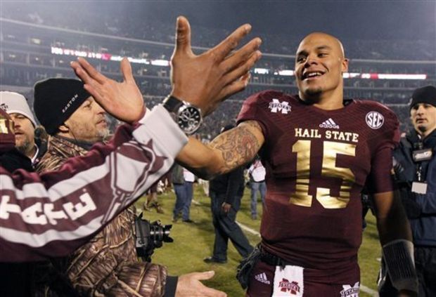 Mississippi State quarterback Dak Prescott (15) celebrates after Mississippi State defeated Mississippi 17-10 in overtime in an NCAA college football game, Thursday, Nov. 28, 2013, in Starkville, Miss. (AP Photo/Rogelio V. Solis)