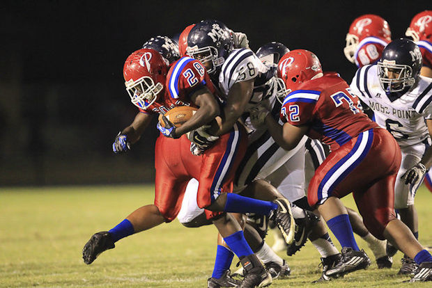 August 22, 2014: Pascagoula Panters DeMyreon Boyce (28) is tackled by Moss Point Tigers Jaylen Logan (58) during the Pascagoula vs Moss Point game at War Memorial Stadium on Friday night. Bobby McDuffie / gulflive.com