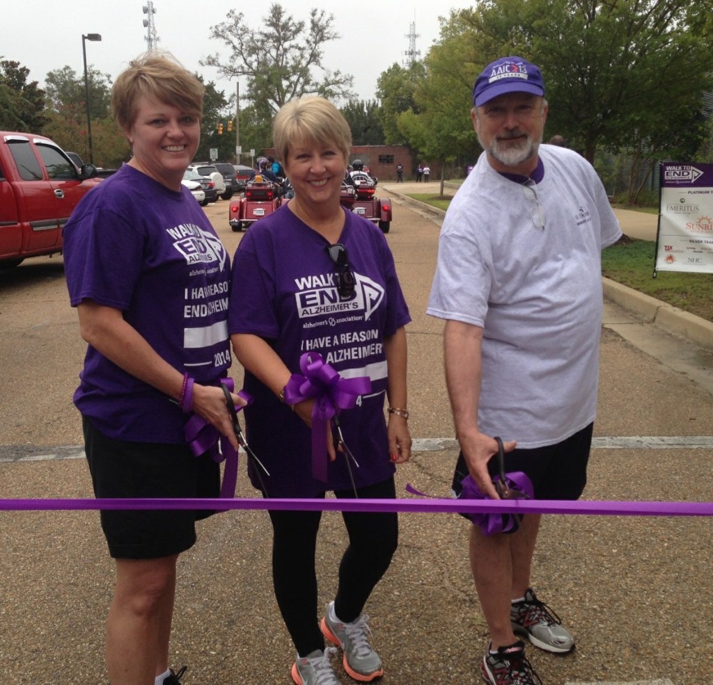 Mississippi First Lady Deborah Bryant (center), Mississippi Chapter Alzheimer’s Association Executive Director Patty Dunn (left) and Board President Marshall Belaga, M.D. participate in the ribbon-cutting to start the walk