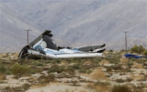 Wreckage lies near the site where a Virgin Galactic space tourism rocket, SpaceShipTwo, exploded and crashed in Mojave, Calif. Friday, Oct. 31, 2014. The explosion killed a pilot aboard and seriously injured another while scattering wreckage in Southern California's Mojave Desert, witnesses and officials said. (AP Photo/Ringo H.W. Chiu)