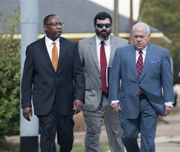 Former Mississippi Corrections Commissioner Chris Epps, left, and his attorney John Colette, right, and Sherwood Colette, arrive at the federal courthouse in Jackson, Miss., Thursday, Nov. 6, 2014. Epps, who resigned abruptly this week, has been charged with accepting hundreds of thousands of dollars in bribes from a Rankin County businessman connected to several private prison companies. (AP Photo/The Clarion-Ledger, Joe Ellis)