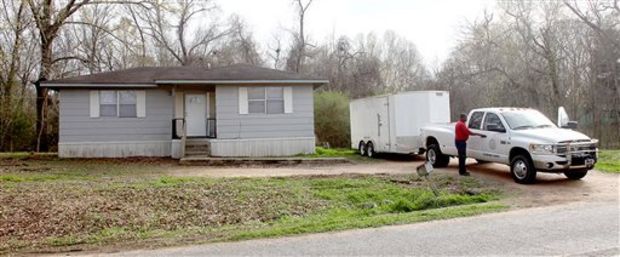 Claiborne County officials prepare to leave a home in Port Gibson, Miss., where authorities were investigating the hanging death of a black man in the neighboring woods, Thursday, March 19, 2015. The man has not been identified. (AP Photo/The Vicksburg Evening Post, Josh Edwards)