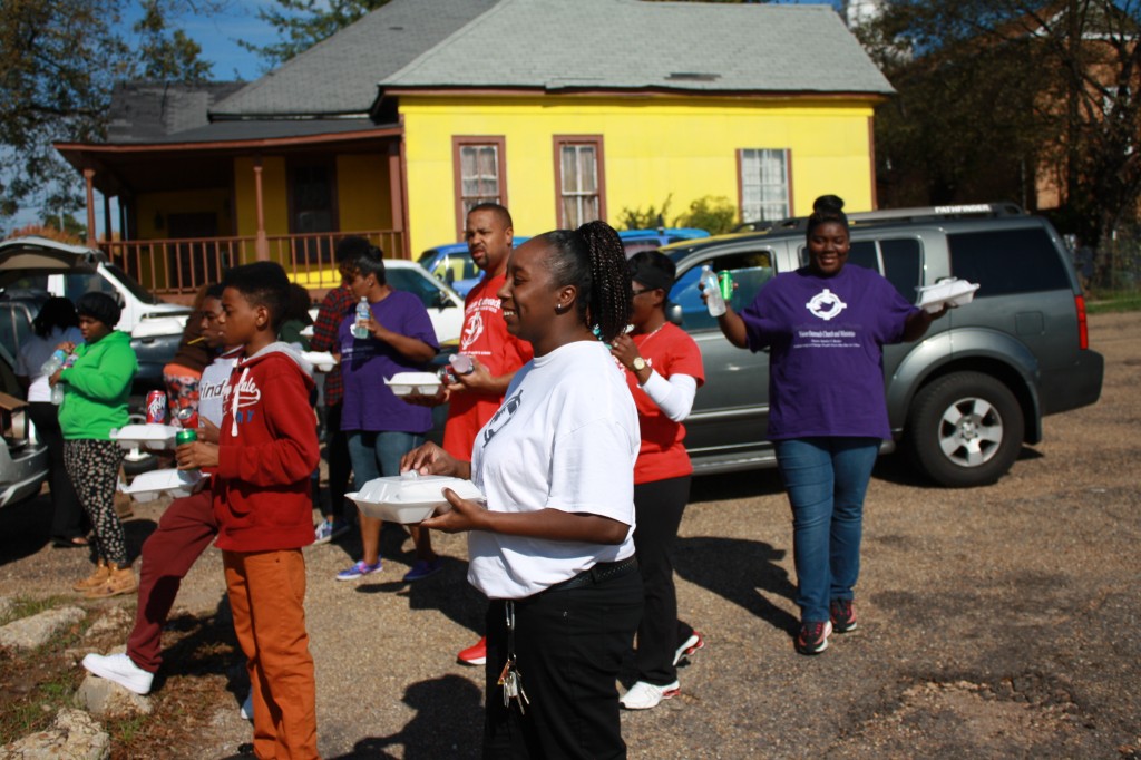 Members of Vision Outreach Church and Ministries await individuals to give meals to on Rose Street in Jackson. Photos by Shanderia K. Posey