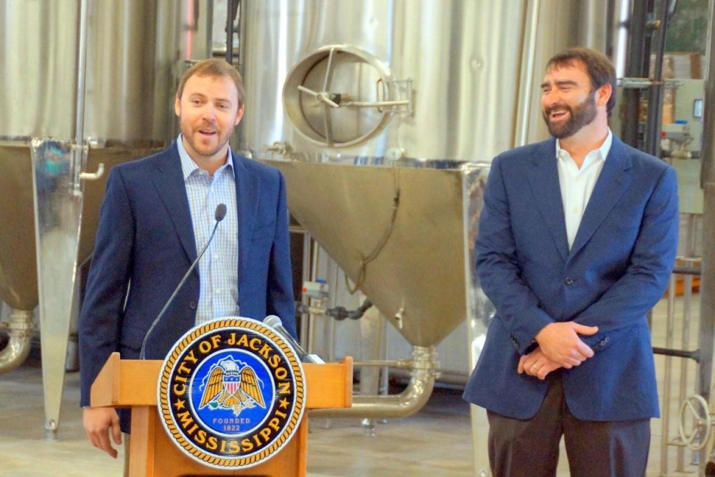 Cathead Distillery owners, Richard Patrick (left) and Austin Evans address the crowd during the ribbon cutting ceremony for the business last week. Photo by Jay Johnson