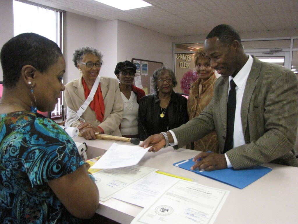 A Chancery Clerk employee and city employee Von Anderson review paperwork for Scott Ford Properties. Looking on are Rep. Alyce Clarke, Scott Ford House Board President Dr. Alferdteen Harrison, Ruth Weir, granddaughter of midwife Virginia Scott Ford; and Scott Ford House Board member Dorothy Stewart. Photo by Janice K. Neal-Vincent, Ph.D.