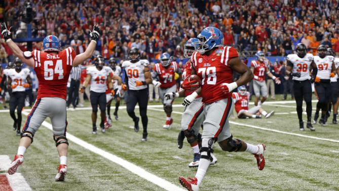 Mississippi offensive lineman Laremy Tunsil (78) carries for a touchdown in the first half of the Sugar Bowl college football game against Oklahoma State in New Orleans, Friday, Jan. 1, 2016. (AP Photo/Bill Feig)