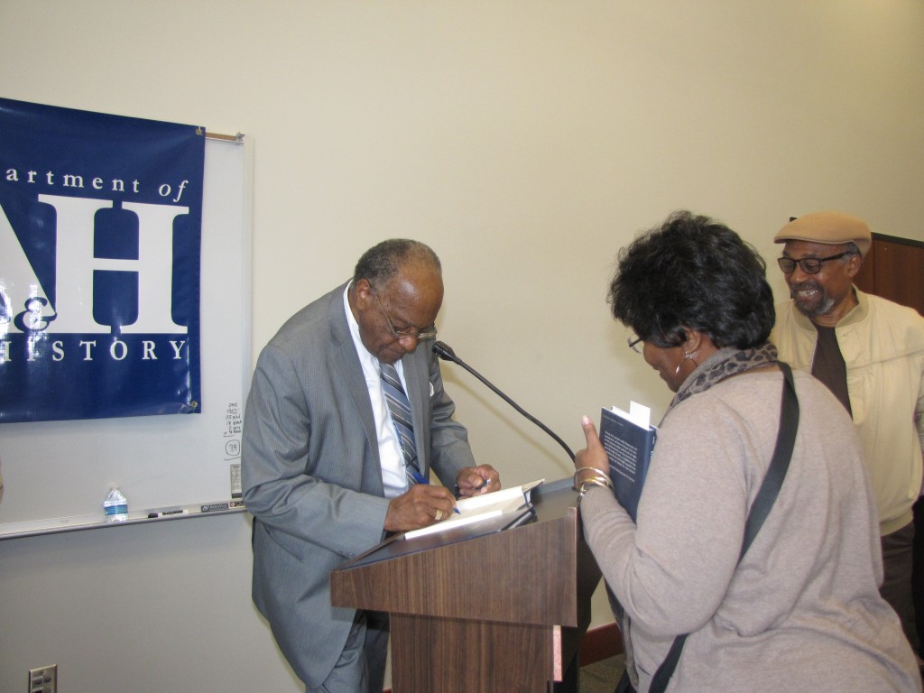 Sen. David Jordan signs book for attender. Photo by Janice K. Neal-Vincent