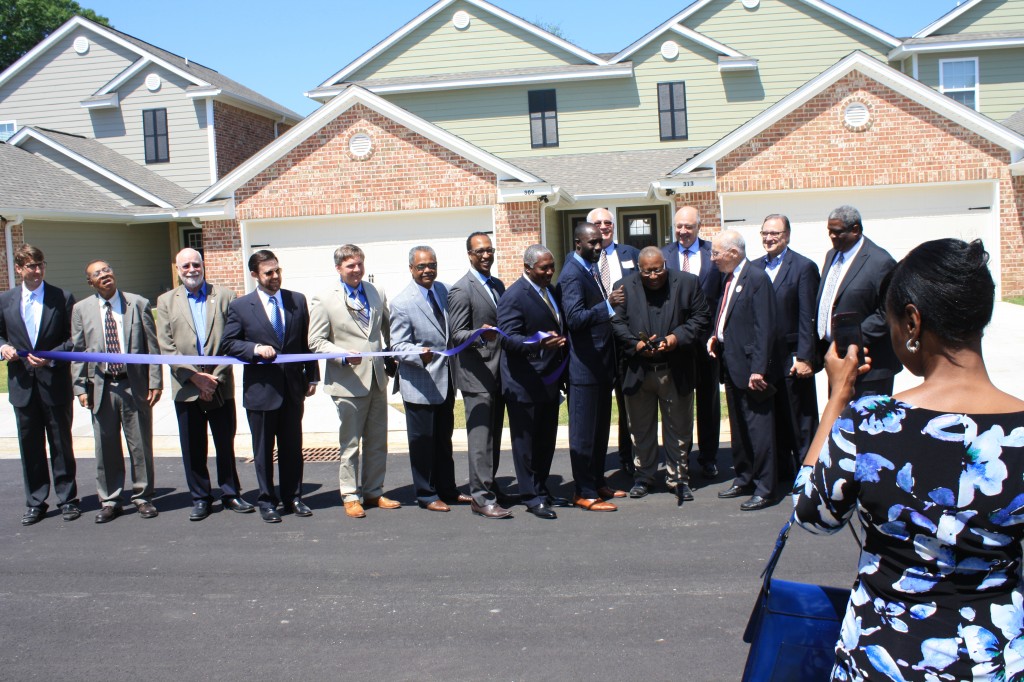 Primus Wheeler, executive director of the Jackson Medical Mall Foundation, cuts the ribbon for the grand opening of East Village Estates. Several city and state leaders, along with development partners, were present for the event. PHOTO BY SHANDERIA K. POSEY