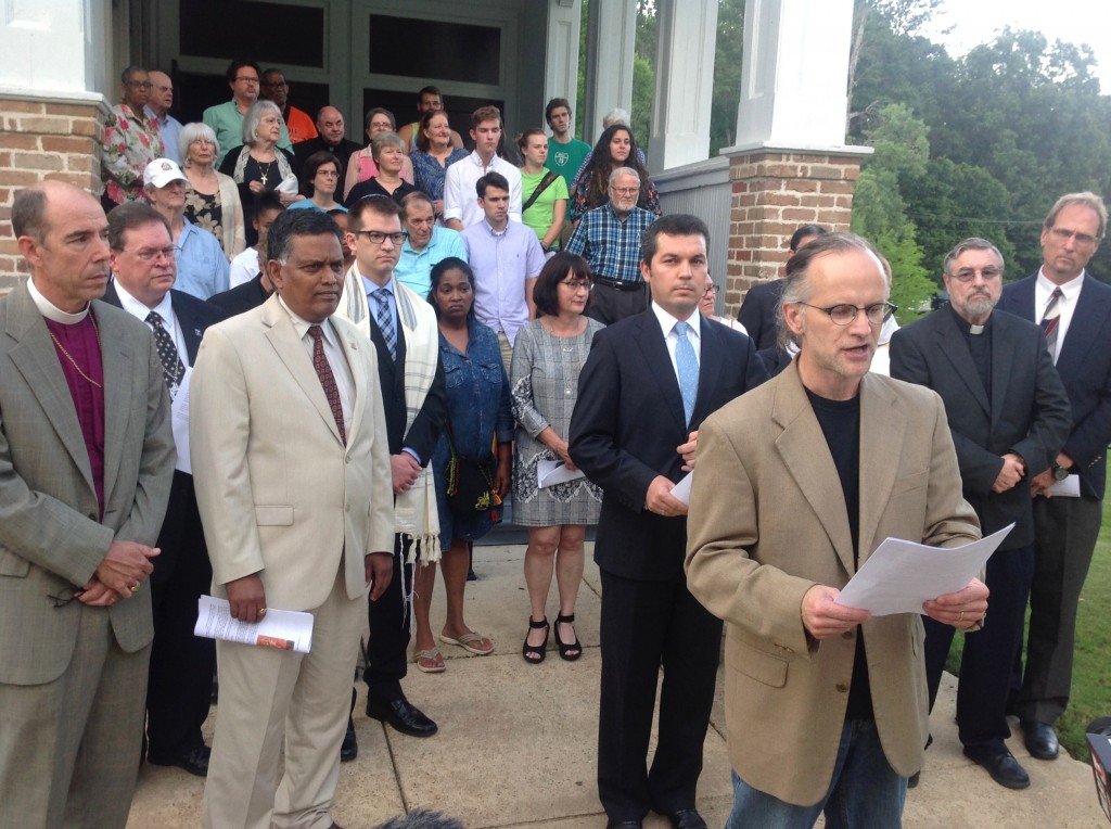 James Bowley (front, center), chair of Religious Studies at Millsaps College and member of the Mississippi Religious Leadership Conference and Voices Against Extremism, addressed the press during the prayer vigil held at Tougaloo College Tuesday evening.  PHOTO BY AYESHA K. MUSTAFAA