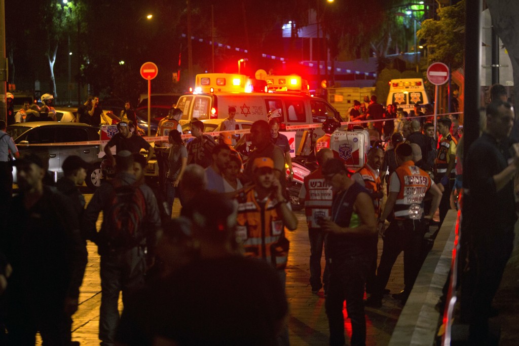 Ambulances are seen at the scene of a shooting attack in Tel Aviv, Israel, Wednesday, June 8, 2016. Two Palestinian gunmen opened fire in central Tel Aviv Wednesday night, killing three people and wounding at least five others, Israel police said. (AP Photo/Sebastian Scheiner)
