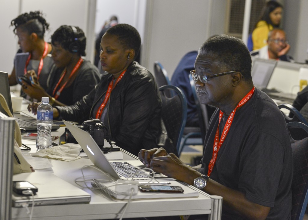 Black Press icon George Curry works on a story in the media center at the 2016 International AIDS Conference in Durban, South Africa. Freddie Allen/AMG/BAI
