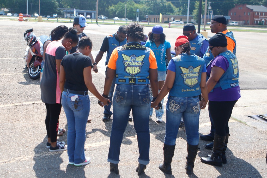 Friends of Fallen Riders, Alpha Kappa Alpha Sorority, Inc., members and National Alliance on Mental Illness staff pray prior to the “Ride Against Stigma.” The ride was in support of Minority Mental Health Awareness Month.