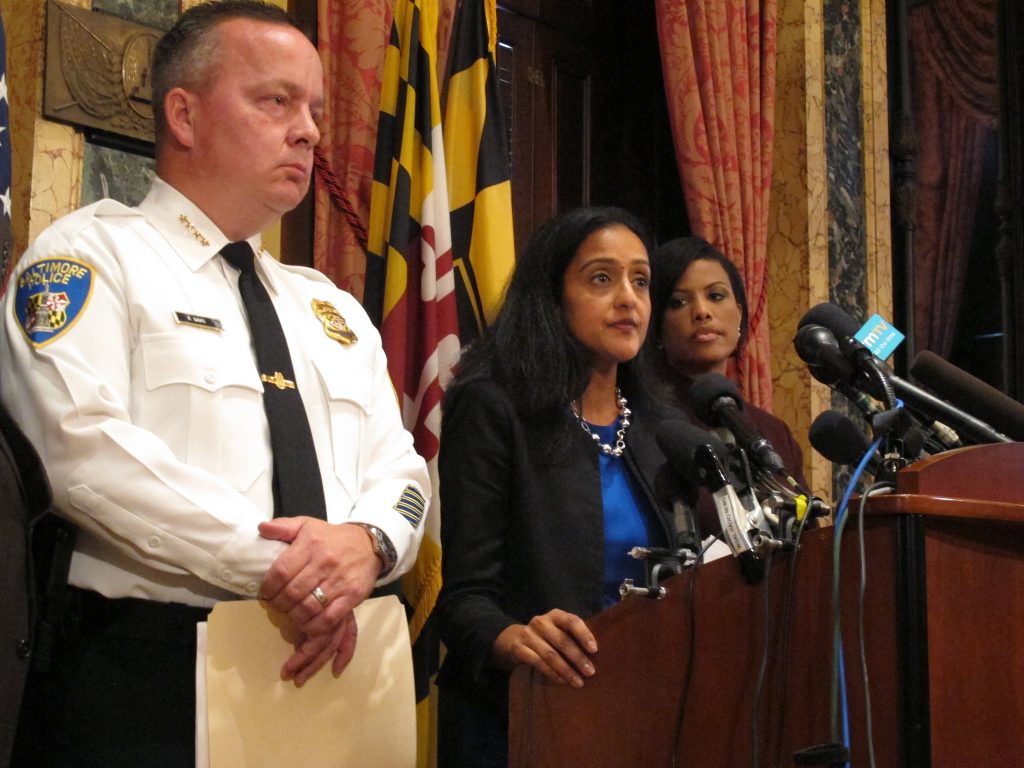 Vanita Gupta, head of the Justice Department's Civil Rights Division, discusses the department's findings on the investigation into the Baltimore City Police Department as Police Commissioner Kevin Davis, left, and Mayor Stephanie Rawlings-Blake, right, listens on Wednesday, Aug. 10, 2016 at City Hall in Baltimore. Brian Witte / AP