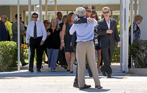 Mourners exit the Parker Playhouse following a memorial service for John Stevens and his wife Michelle Mishcon, Friday, Aug. 19, 2016, in Fort Lauderdale, Fla. A Florida sheriff's office said Friday, that Austin Harrouff, 19, will be charged with two counts of first-degree murder in the couples death, raising the possibility of the death penalty. (Mike Stocker/South Florida Sun-Sentinel)