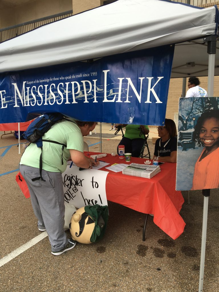 Mississippi Link Publisher Jackie Hampton looks on as a resident registers to vote Sept. 25 in Jackson. PHOTO BY SHANDERIA K. POSEY
