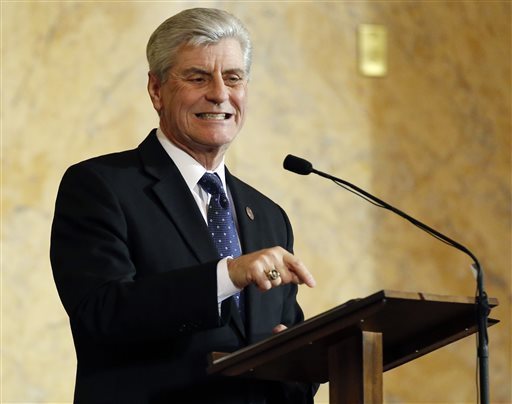 Republican Gov. Phil Bryant delivers his State of the State address before a joint legislative session in House chambers at the Capitol in Jackson, Miss., Tuesday, Jan. 26, 2016. Wednesday, Bryant announced he was cutting nearly $57 million from the state budget to offset an accounting error. AP file photo