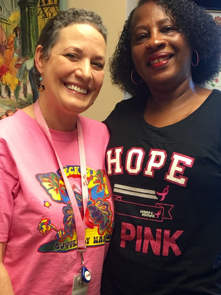 Rebecca Foust (left) and Vernessa Cheatham are breast cancer “survivor sisters” and co-workers.