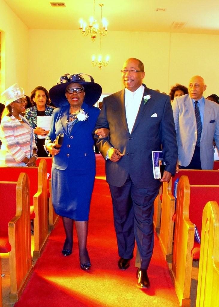 College Hill church member Lenora Reed escorts Pastor Michael T. Williams into the sanctuary for the pastor’s sixth anniversary celebration. PHOTO BY JAY JOHNSON