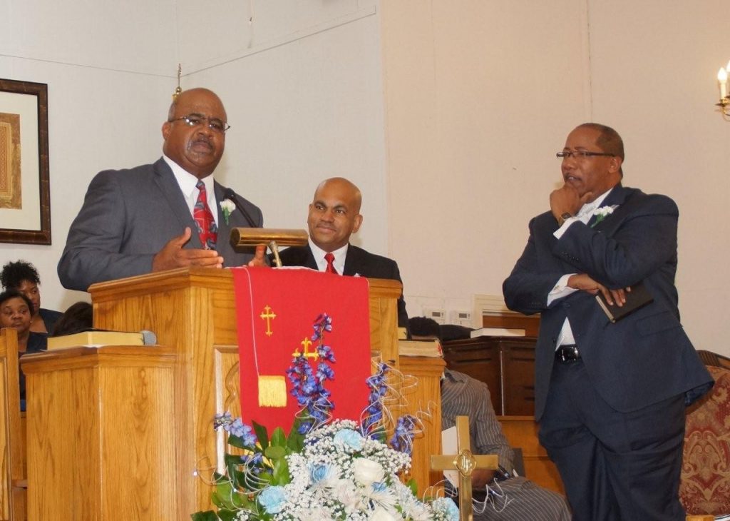 Guest Speaker, the Rev. Lee Carson of First Baptist M.B. Church in Kosciusko, delivers the message as Rev. William Wheeler and Pastor Michael Williams (right) look on. PHOTO BY JAY JOHNSON