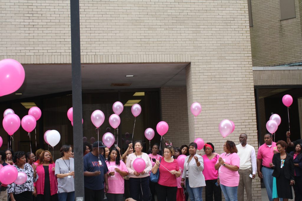 In their fight against breast cancer and hope for a cure, supporters release pink balloons in the air.
