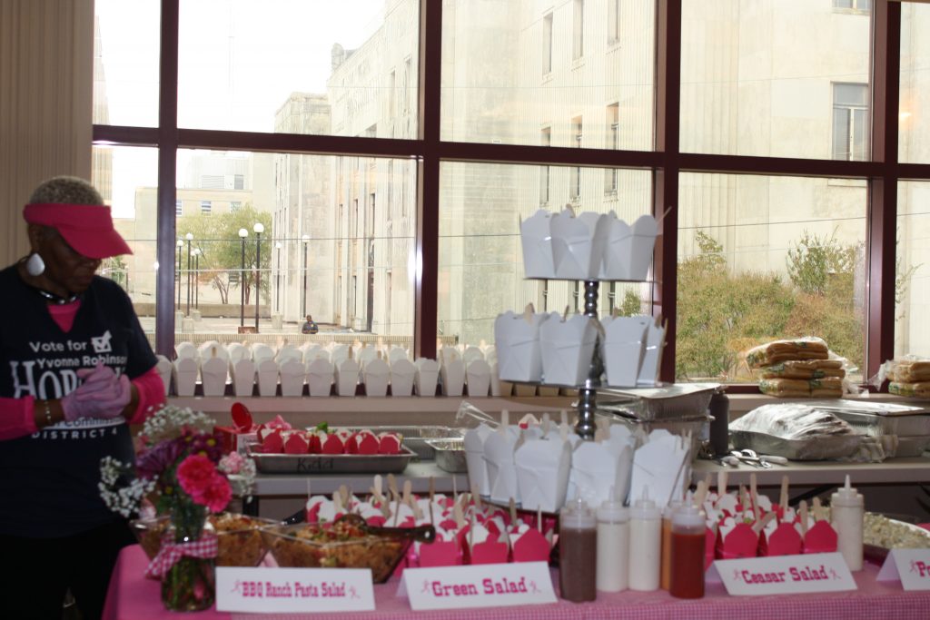 A food attendant serves a hearty meal for all who attended the breast cancer awareness event.
