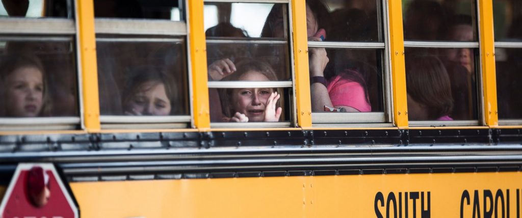 A Townville Elementary student looks out of the window of a school bus as she and her classmates are transported to Oakdale Baptist Church, following a shooting at Townville Elementary in Townville Wednesday, Sept. 28, 2016. A teenager killed his father at his home Wednesday before going to the nearby elementary school and opening fire with a handgun, wounding two students and a teacher, authorities said. (Katie McLean/The Independent-Mail via AP)