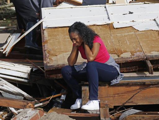 Shanise McMorris grieves on the slab of her Hattiesburg, Miss., home after an early tornado hit the city, Saturday, Jan. 21, 2017.  The tornado was part of a wall of stormy weather traveling across the region, bringing with it rain and unstable conditions.  (AP Photo/Rogelio V. Solis)