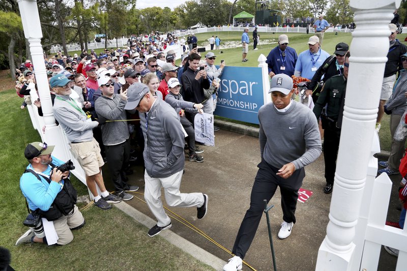 Tiger Woods leaves the practice green moments before driving the first tee while playing the Copperhead Course on Thursday, March 8, 2018, during the first round of the Valspar Championship at the Innisbrook Golf and Spa Resort in Palm Harbor, Fla. (Douglas R. Clifford/The Tampa Bay Times via AP)