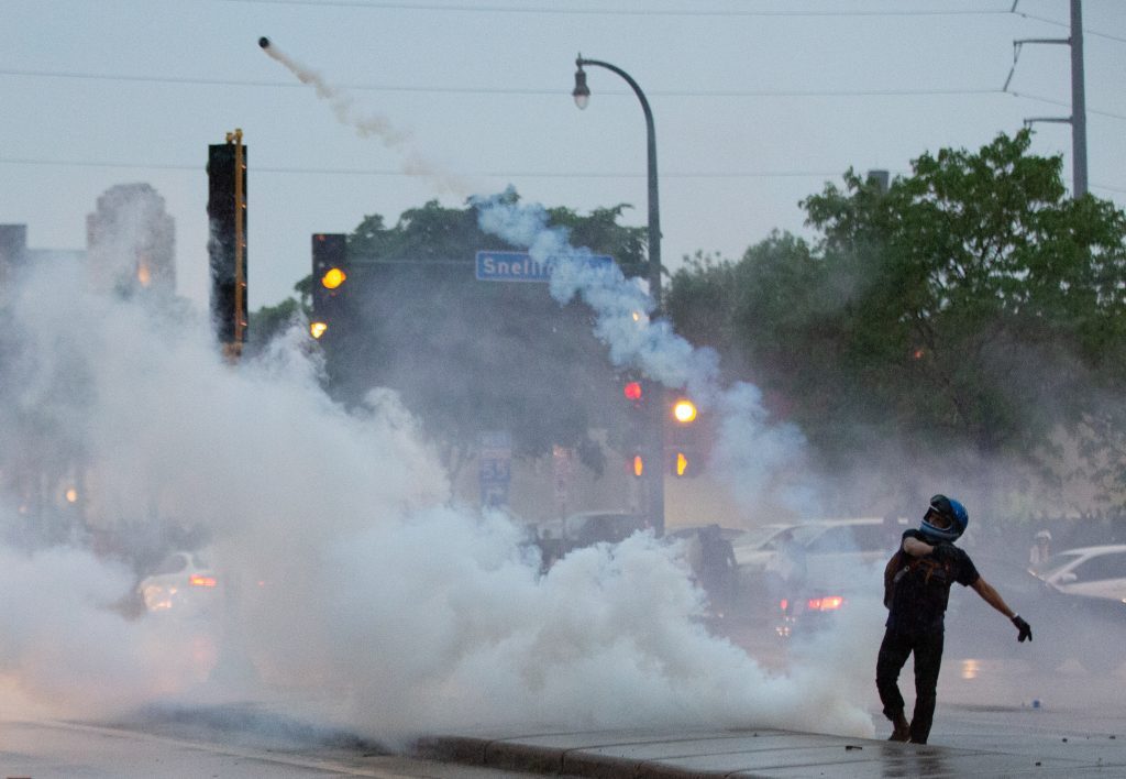 A protester throws a gas canister back at police during a protest over the killing of George Floyd in Minneapolis on May 26, 2020. (Chris Juhn/Zenger) 